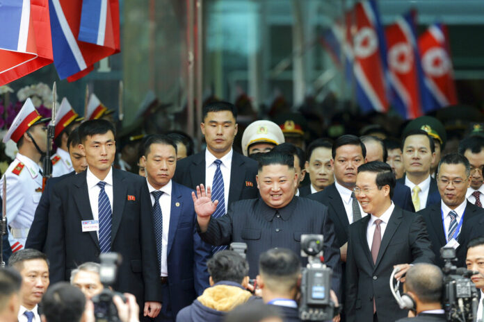 North Korean leader Kim Jong Un waves Tuesday upon arrival by train in Dong Dang in Vietnamese border town. Photo: Minh Hoang / Associated Press