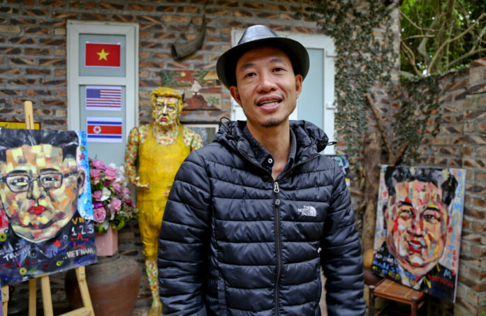 In this Feb. 25, 2019, photo, Tran Lam Binh poses for a photo with part of his creations in Hanoi, Vietnam. Photo: Tran Van Minh / Associated Press