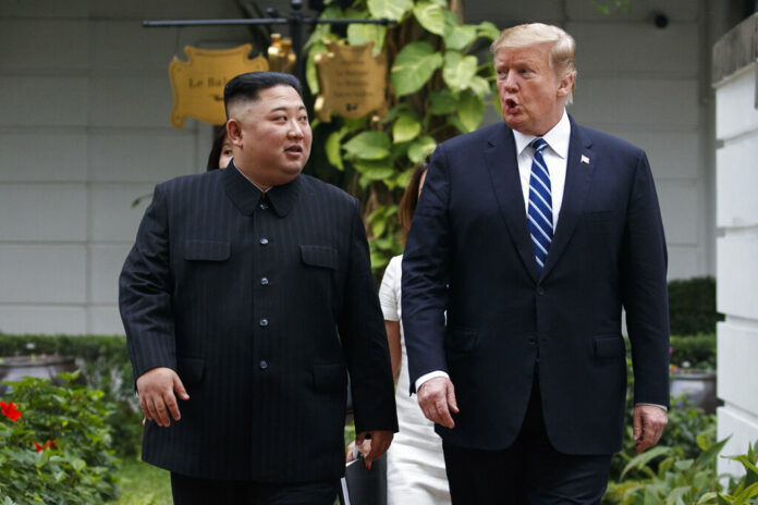 President Donald Trump and North Korean leader Kim Jong Un take a walk Thursday after their first meeting at the Sofitel Legend Metropole Hanoi hotel. Photo: Evan Vucci / Associated Press