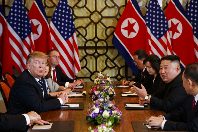 President Donald Trump listens as North Korean leader Kim Jong Un answers a question from reporters Thursday during a meeting in Hanoi, Vietnam. Photo: Evan Vucci / Associated Press