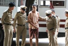 Australia Scraps Game in Thailand, Campaigns to Free Refugee Hakeem AlAraibi is led by police Monday at the Criminal Court in Bangkok.