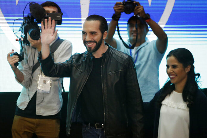 President elect Nayib Bukele of the Grand Alliance for National Unity waves while accompanied by his wife Gabriela before giving a press conference Sunday in San Salvador, El Salvador. Photo: Moises Castillo / Associated Press