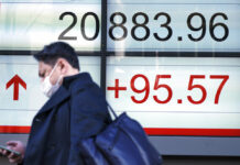 Asian Shares Lower as Tariffs Delay Rally Fades A man walks past an electronic stock board showing Japan's Nikkei 225 index at a securities firm Feb. 4 in Tokyo. Photo: Eugene Hoshiko / Associated Press