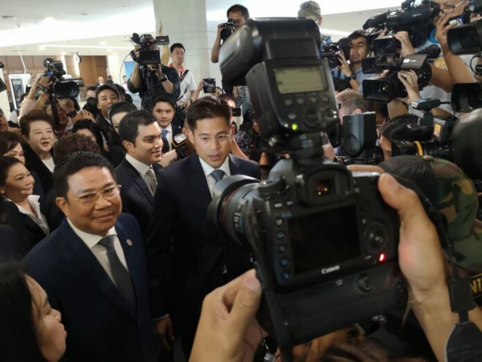 Thai Raksa Chart Party leader Preechapol Pongpanich talks to reporters Friday morning outside the Election Commission in Bangkok.