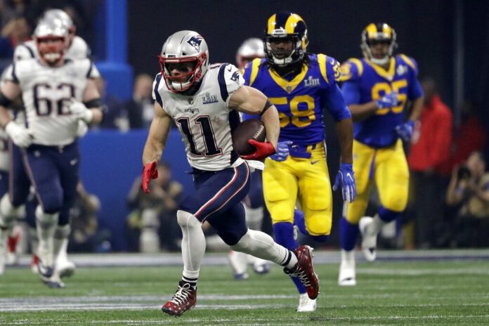 New England Patriots' Julian Edelman (11) runs the ball ahead of Los Angeles Rams' Cory Littleton (58) during the second half of the NFL Super Bowl 53 football game on Sunday in Atlanta. Photo: Jeff Roberson / Associated Press
