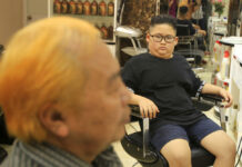Kim or Trump? Hanoi Barber Offers Free Hairdos Le Phuc Hai, 66, at left, and To Gia Huy, 9, sit after having Trump and Kim haircuts Tuesday in Hanoi. Photo: Hau Dinh / Associated Press