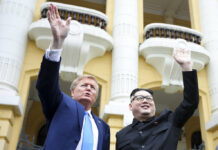 Kim, Trump Impersonators Draw Ire of Vietnam Authorities U.S. President Donald Trump impersonator Russell White, at left, and Kim Jong-un impersonator Howard X pose for photos Friday outside the Opera House in Hanoi. Photo: Minh Hoang / Associated Press