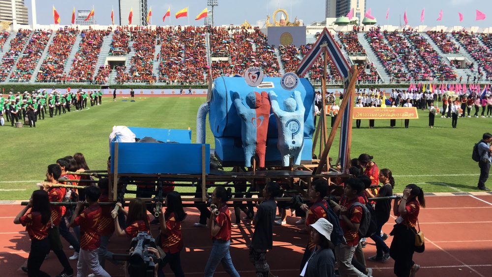 A float carried by students shows junta chairman Prayuth Chan-ocha literally leeching support from political parties including the Democrat and Bhum Jai Thai parties at Saturday's CU-TU game.