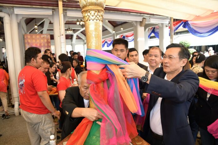 Thai Raksa Chart Party members pray at the City Pillar Shrine for luck Tuesday before registering as candidates for the March election.