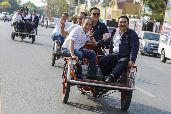 Bhumjaithai Party members campaign from a saleng Wednesday in Nakhon Sawan province. Bhumjaithai Party members campaign from a saleng Wednesday in Nakhon Sawan province.