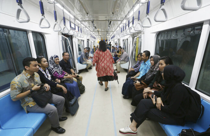 People ride on a Mass Rapid Transit (MRT) in February during a trial run in Jakarta, Indonesia. Photo: Achmad Ibrahim / Associated Press People ride on a Mass Rapid Transit (MRT) in February during a trial run in Jakarta, Indonesia. Photo: Achmad Ibrahim / Associated Press