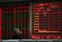 Asian Shares Mixed Following Rebound on Wall Street An investor monitors share prices at a brokerage house in Beijing, Wednesday, March 27, 2019. Photo: Andy Wong / Associated Press