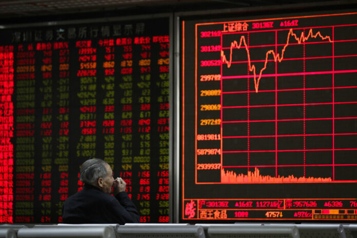 An investor monitors share prices at a brokerage house in Beijing, Wednesday, March 27, 2019. Photo: Andy Wong / Associated Press