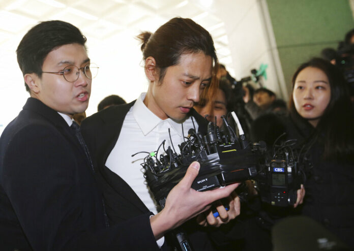 K-pop singer Jung Joon-young, center, arrives Thursday at the Seoul Metropolitan Police Agency in Seoul, South Korea. Photo: Ahn Young-joon / Associated Press