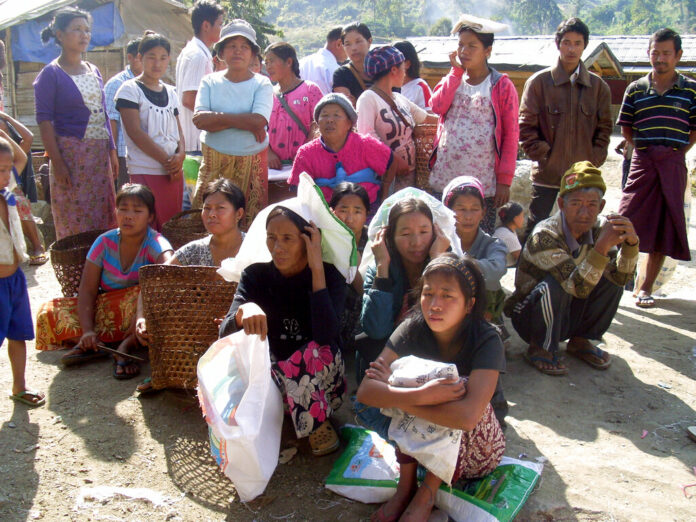 Kachin refugees wait for rations in 2013 at the Je Yang IDP camp, the biggest and closest camp to Laiza, Laiza, northeastern Myanmar. Photo: Yadana Htun / Associated Press