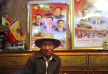 China Defends Tibet Policies, Bashes Exile Government In this Sept. 17, 2015 file photo, Dronjie, 69, sits in his home near two posters displaying the images of current and former leaders of China in Lhasa, capital of the Tibet Autonomous Region of China. Photo: Aritz Parra / Associated Press