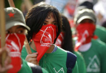 Philippine Police Kill 14 Men Rights Groups Say Were Farmers In this March 25, 2019, file photo, masked members of the outlawed National Democratic Front of the Philippines, the umbrella organization of the Philippine communist movement, listen during a demonstration in Manila, Philippines. Photo: Aaron Favila / Associated Press