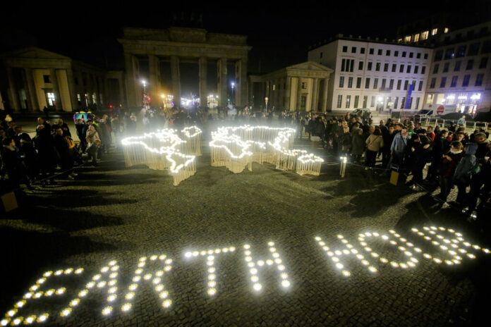 Activists of the World Wide Fund For Nature (WWF) set up led-lights Saturday in front of the blacked out Brandenburg Gate in Berlin, Germany to mark Earth Hour. Photo: Markus Schreiber / Associated Press