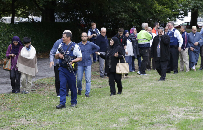 Police escort witnesses away from a mosque Friday in central Christchurch, New Zealand Photo: Mark Baker / Associated Press Police escort witnesses away from a mosque Friday in central Christchurch, New Zealand Photo: Mark Baker / Associated Press