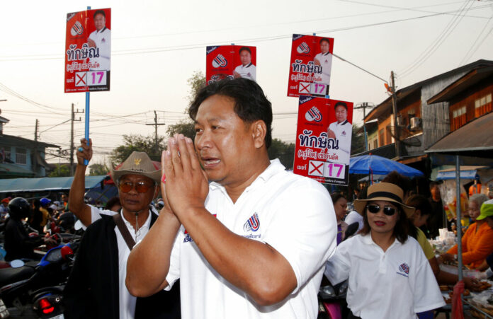 Veerawit Chuajunud, center, who changed his name to Thaksin Chuajunud for Pheu Chart party, makes his election campaign Friday in Nakhon Ratchasima province. Photo: Sakchai Lalit / Associated Press