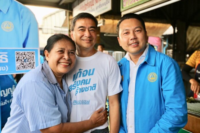 A woman hugs Democrat Party chairman Abhisit Vejjajiva during his campaign in Bangkok.