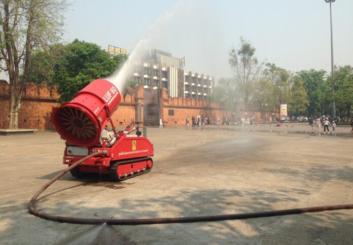 A water cannon sprays water to reduce dust particles in Chiang Mai province.