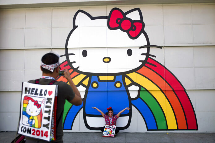 FILE - In this Oct. 30, 2014, file photo, Keith Nunez, left, takes pictures of his wife, Carolina, at the first-ever Hello Kitty fan convention, Hello Kitty Con, at the Geffen Contemporary at MOCA in Los Angeles. Photo: Jae C. Hong / Associated Press