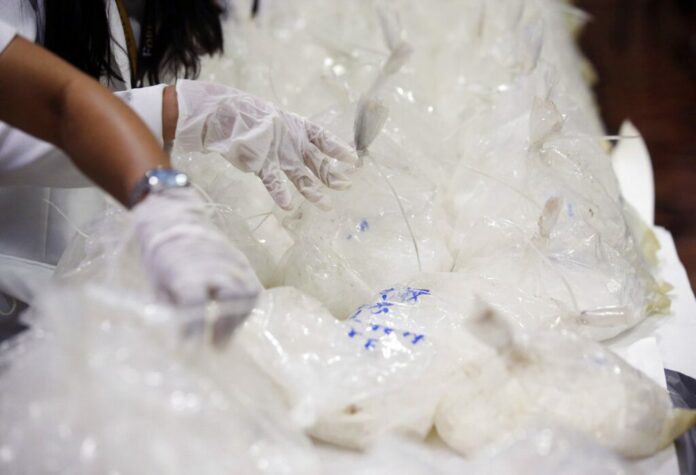 In this May 29, 2017, file photo, members of the National Bureau of Investigation arrange packs of seized methamphetamine at the National Bureau of Investigation in Manila, Philippines. Photo: Aaron Favila / Associated Press
