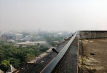 Chiang Mai Tops World Pollution Charts A nozzle sprays water from atop a building Monday in Chiang Mai as the city is covered with smog.