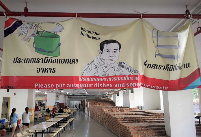 A poster with an image of junta leader Prayuth Chan-ocha telling Thammasat University students to put their dishes at proper places after eating at a canteen. A poster with an image of junta leader Prayuth Chan-ocha telling Thammasat University students to put their dishes at proper places after eating at a canteen.
