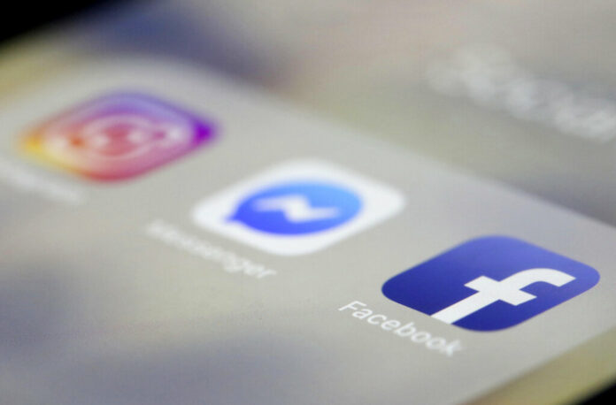 Facebook, Messenger and Instagram apps displayed on an iPhone in a photo taken Wednesday. Photo: Jenny Kane / Associated Press