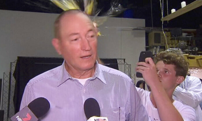 A teenager breaks an egg on the head of Australian Sen. Fraser Anning while he holds a press conference Saturday in Melbourne. Photo: Associated Press