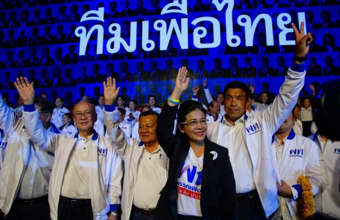 The leader of Pheu Thai Party and candidate for prime minister Sudarat Keyuraphan, second from right, and candidates wave during a Friday election rally in Bangkok. Photo: Gemunu Amarasinghe / Associated Press