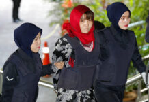 Malaysia Won’t Drop Case Against Vietnamese in Kim Killing Vietnamese Doan Thi Huong, at center, is escorted by police into the Shah Alam High Court on Thursday in Shah Alam, Malaysia. Photo: Vincent Thian / Associated Press