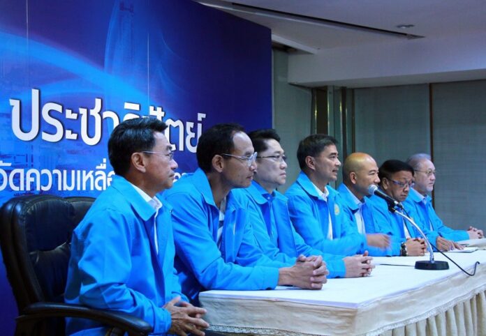 Flanked by other Democrat Party executives, chairman Abhisit Vejjajiva speaks at a Monday news conference at their offices in Bangkok.