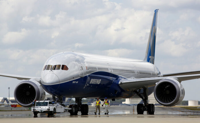 In this March 31, 2017, file photo, Boeing employees walk the new Boeing 787-10 Dreamliner down towards the delivery ramp area at the company's facility in South Carolina after conducting its first test flight at Charleston International Airport in North Charleston, S.C. Photo: Mic Smith / Associated Press