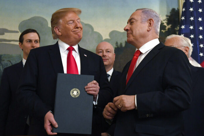 In this Monday, March 25, 2019 file photo, President Donald Trump smiles at Israeli Prime Minister Benjamin Netanyahu, right, after signing a proclamation in the Diplomatic Reception Room at the White House in Washington. Photo: Susan Walsh / Associated Press