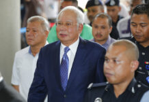 Malaysian Ex-PM Najib Attends 1st Day of Graft Trial Former Malaysian Prime Minister Najib Razak, center, walks into a courtroom Wednesday at Kuala Lumpur High Court in Kuala Lumpur, Malaysia. Photo: Vincent Thian / Associated Press