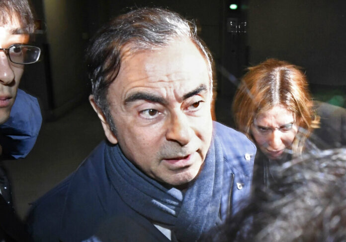 In this April 3, 2019, file photo, former Nissan Chairman Carlos Ghosn, center, leaves his lawyer's office in Tokyo. Photo: Sadayuki Goto / Kyodo News via AP