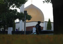 50 Murder Counts Filed on NZ Mosque Attack Suspect In this March 17, 2019, file photo, a police officer stands guard in front of the Al Noor mosque in Christchurch, New Zealand. Photo: Vincent Yu / Associated Press