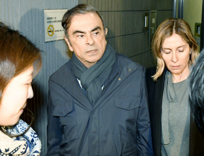 Former Nissan Chairman Carlos Ghosn, center, leaves his lawyer's office in Tokyo, Wednesday, April 3, 2019. Photo: Sadayuki Goto / Kyodo News via AP