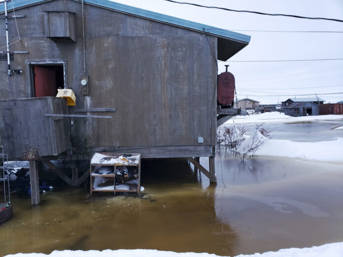 In this Feb. 12, 2019 photo provided by Philomena Keys, high water pushed up the Yukon River from the Bering Sea floods yards around homes in the western village of Kotlik, Alaska. Photo: Philomena Keys via AP