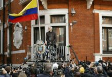 WikiLeaks’ Assange Arrested in London, Withdrawn Asylum Status In this file photo dated Friday May 19, 2017, watched by the media WikiLeaks founder Julian Assange looks out from the balcony of the Ecuadorian embassy prior to speaking, in London. Photo: Matt Dunham / Associated Press