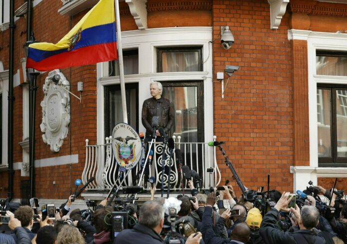 Britain Assange In this file photo dated Friday May 19, 2017, watched by the media WikiLeaks founder Julian Assange looks out from the balcony of the Ecuadorian embassy prior to speaking, in London. Photo: Matt Dunham / Associated Press