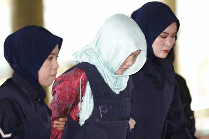 Doan Thi Huong Vietnamese Doan Thi Huong, center, is escorted by police as she arrives at Shah Alam High Court in Shah Alam, Malaysia, Monday, April 1, 2019. Photo: Vincent Thian / Associated Press