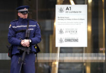 NZ Mosque Suspect to Undergo Mental Health Check A armed police office stands guard Friday outside the entrance to the High Court in Christchurch, New Zealand. Photo: Mark Baker / Associated Press
