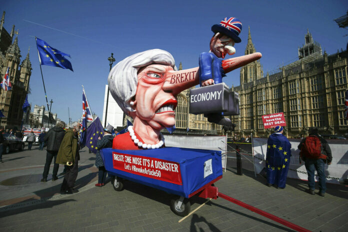 Anti-Brexit demonstrators with an effigy of British Prime Minister Theresa May near College Green at the Houses of Parliament in London, Monday, April 1, 2019.. Photo: Jonathan Brady / PA via AP