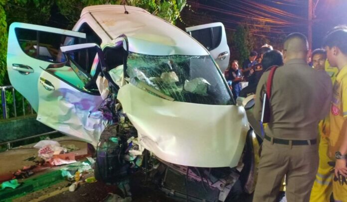 Police and rescue workers stand at the scene of car crash Thursday night that killed a policeman and his wife in Bangkok.