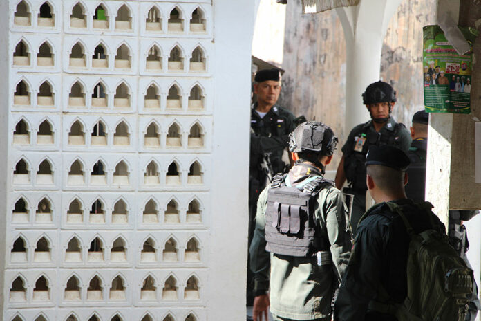 Police and soldiers on Friday at a mosque in Yala province where two border patrol police were shot to death.