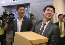 Future Forward May Sue EC For Dereliction of Duty: Piyabutr Future Forward Party leader Thanathorn Juangroongruamgkit, left, and party secretary general Piyabutr Saengkanokkul, right, at the Election Commission on Tuesday. Photo: Matichon